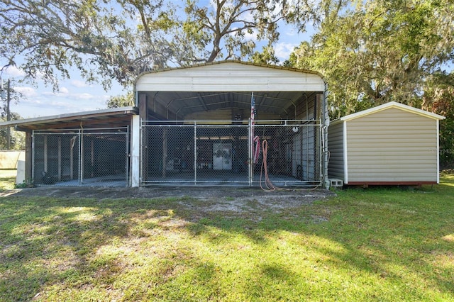 view of outdoor structure featuring a yard and a carport