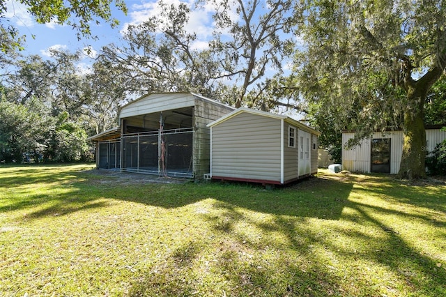 view of outbuilding with a lawn