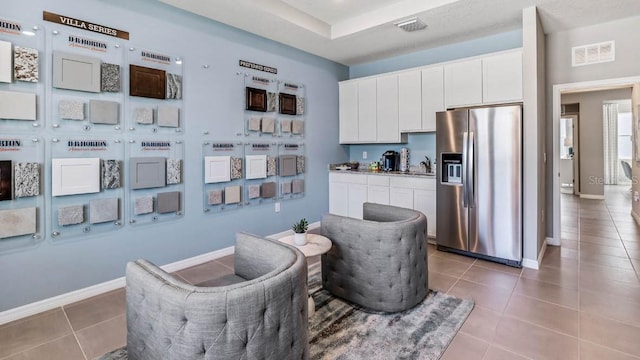 living area with sink and tile patterned flooring