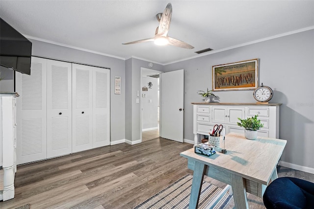 office featuring ceiling fan, crown molding, and hardwood / wood-style floors