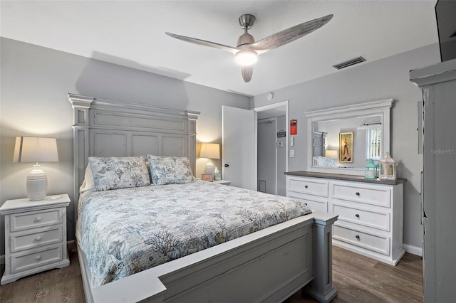 bedroom with dark hardwood / wood-style floors and ceiling fan