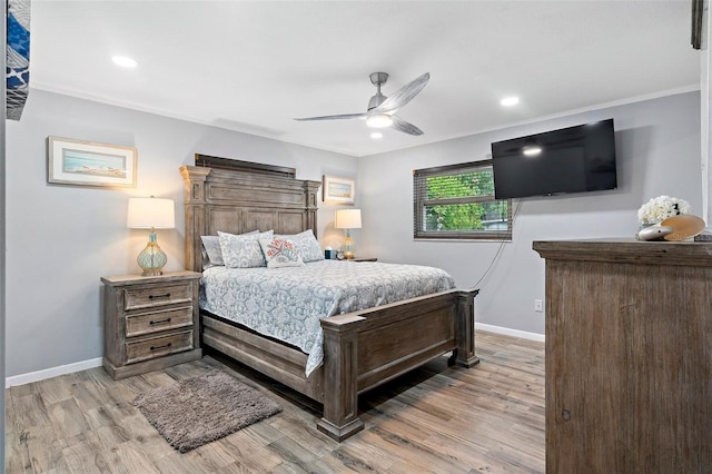 bedroom with ceiling fan, ornamental molding, and light wood-type flooring