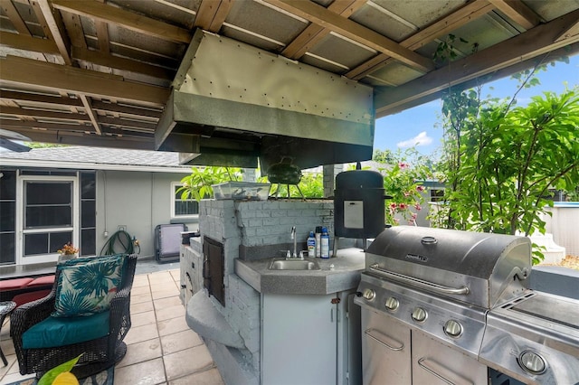 view of patio featuring area for grilling and sink