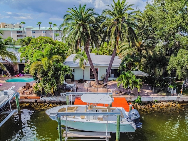 view of dock featuring a patio area, a swimming pool, and a water view