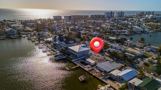 aerial view at dusk featuring a water view