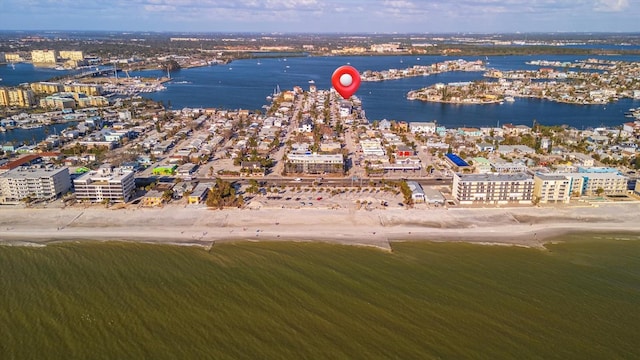 birds eye view of property with a water view and a view of the beach