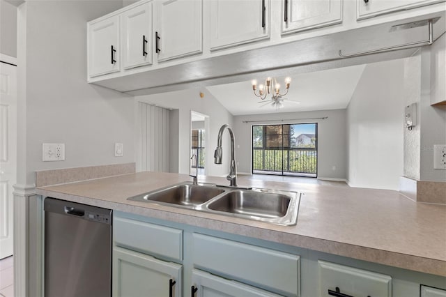 kitchen featuring lofted ceiling, sink, dishwasher, white cabinetry, and a notable chandelier