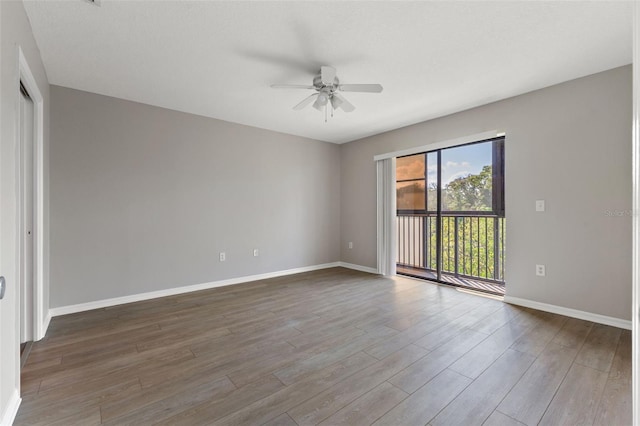 empty room with dark wood-type flooring and ceiling fan