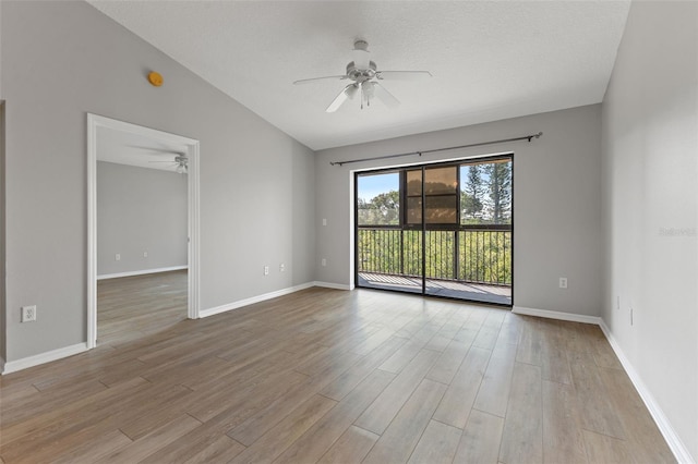 unfurnished room with a textured ceiling, light hardwood / wood-style flooring, ceiling fan, and vaulted ceiling