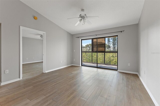 1662 Seascape Cir Unit 205, Tarpon Springs, FL 34689 - empty room featuring ceiling fan, wood finished floors, vaulted ceiling, and baseboards