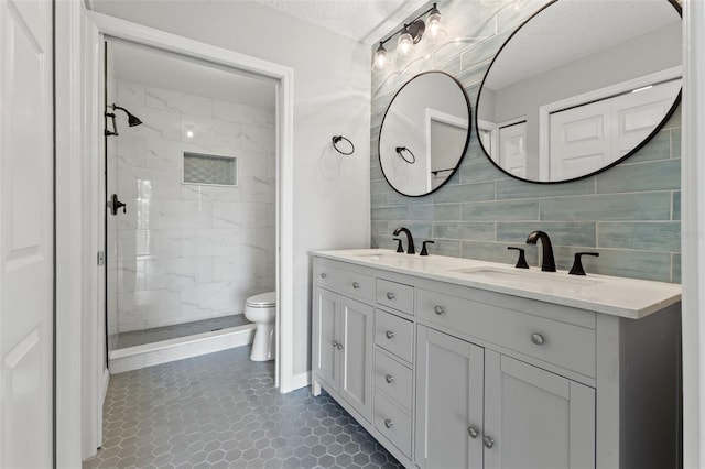 1662 Seascape Cir Unit 205, Tarpon Springs, FL 34689 - bathroom featuring double vanity, toilet, a marble finish shower, and backsplash