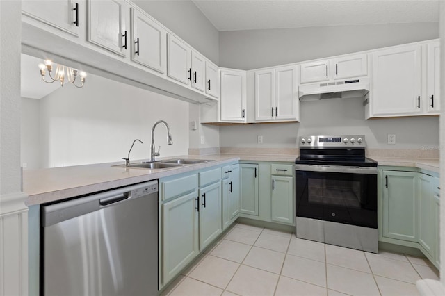 kitchen with light tile patterned flooring, lofted ceiling, sink, appliances with stainless steel finishes, and white cabinets