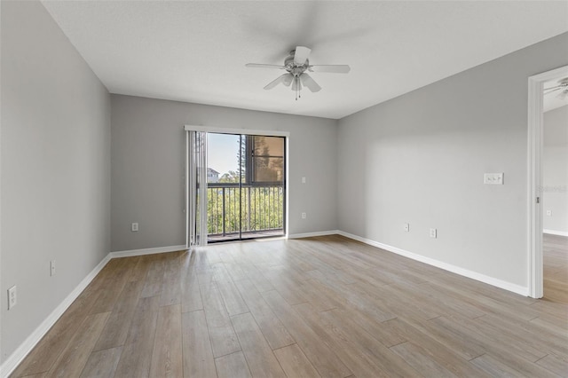 spare room with light wood-type flooring and ceiling fan