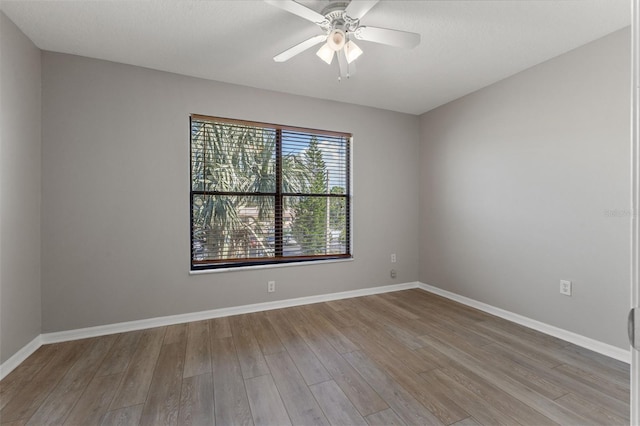 spare room with light hardwood / wood-style floors and ceiling fan