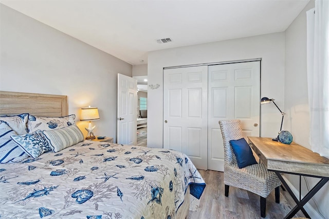 bedroom featuring light hardwood / wood-style floors and a closet