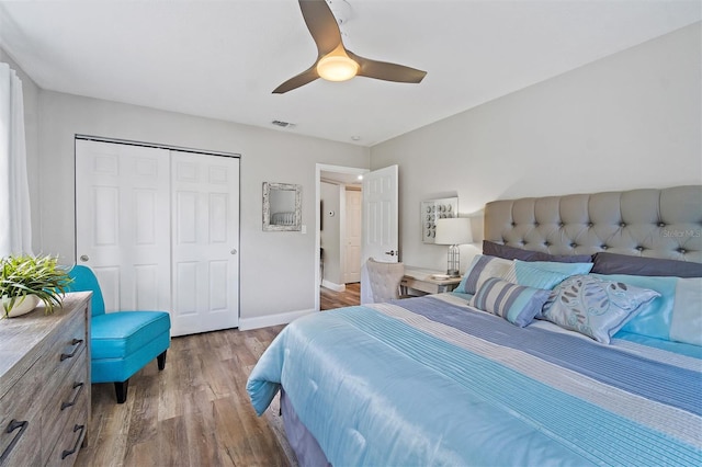 bedroom with a closet, hardwood / wood-style flooring, and ceiling fan