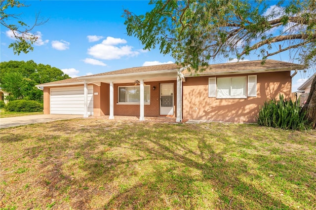 5621 Moog Rd, New Port Richey, FL 34652 - ranch-style home with covered porch, concrete driveway, a front yard, and a garage