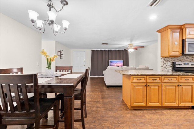 5621 Moog Rd, New Port Richey, FL 34652 - dining space with dark wood-type flooring, a ceiling fan, and a chandelier