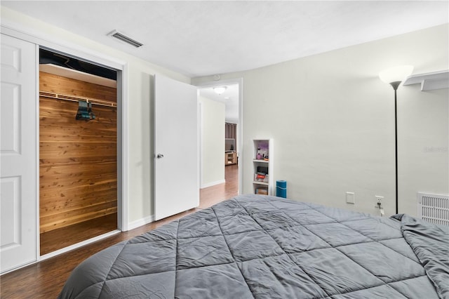 5621 Moog Rd, New Port Richey, FL 34652 - bedroom with wood finished floors, wood walls, and a closet