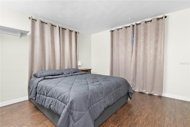 bedroom with dark wood-type flooring