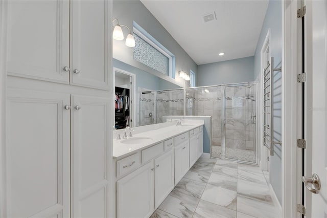 bathroom featuring vanity and an enclosed shower