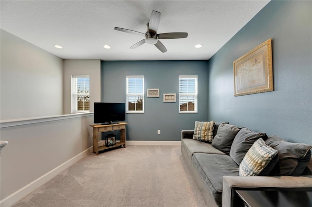 living room with baseboards, light carpet, a ceiling fan, and recessed lighting