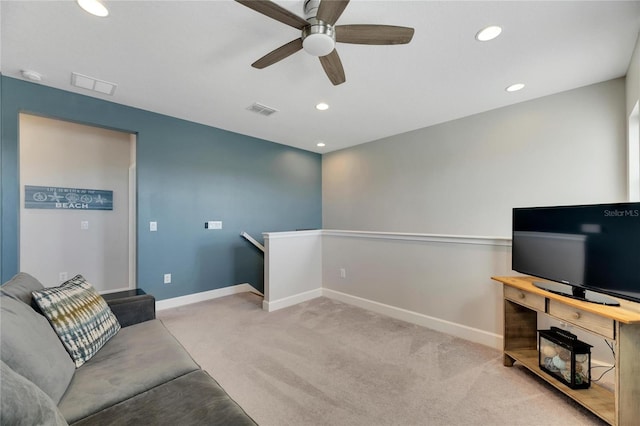 sitting room with ceiling fan and light colored carpet