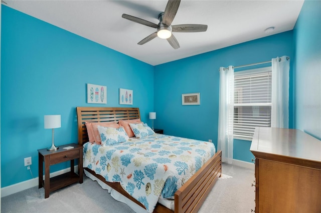 bedroom featuring baseboards, carpet flooring, and a ceiling fan