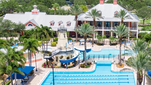 view of swimming pool featuring a water slide and a patio area