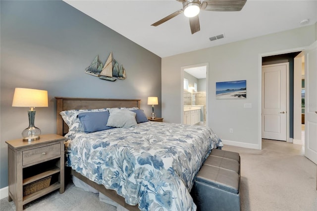 bedroom with light colored carpet, connected bathroom, and ceiling fan