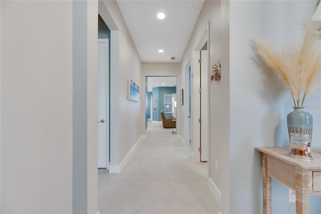 corridor featuring light tile patterned floors