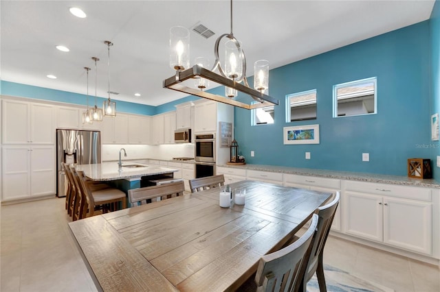 dining area featuring light tile patterned flooring and sink