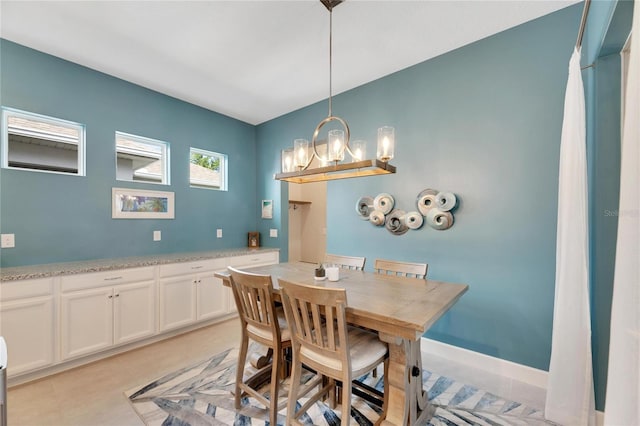 dining area with a notable chandelier and light tile patterned floors