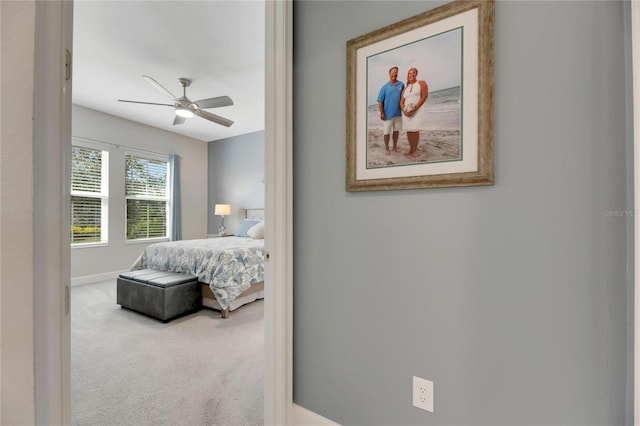 bedroom featuring ceiling fan and light carpet