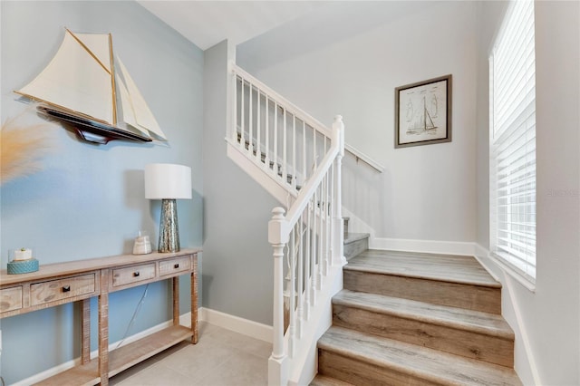 staircase featuring tile patterned floors