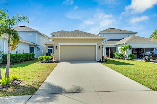 view of front of property featuring a front yard and a garage