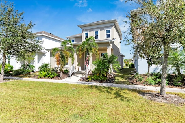 view of front of home with a front yard and covered porch