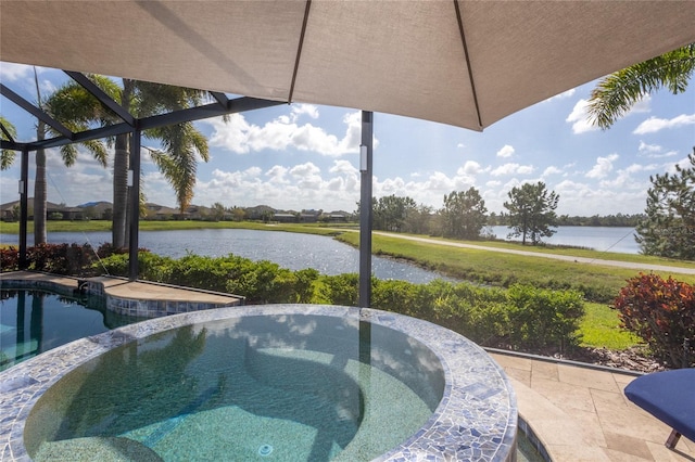 view of swimming pool featuring a patio, an in ground hot tub, and a water view