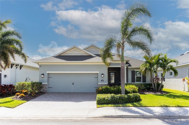 view of front of house with a front yard and a garage