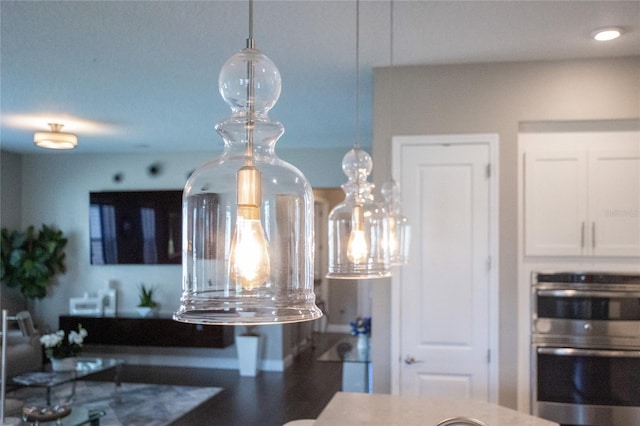 details featuring white cabinets and double oven