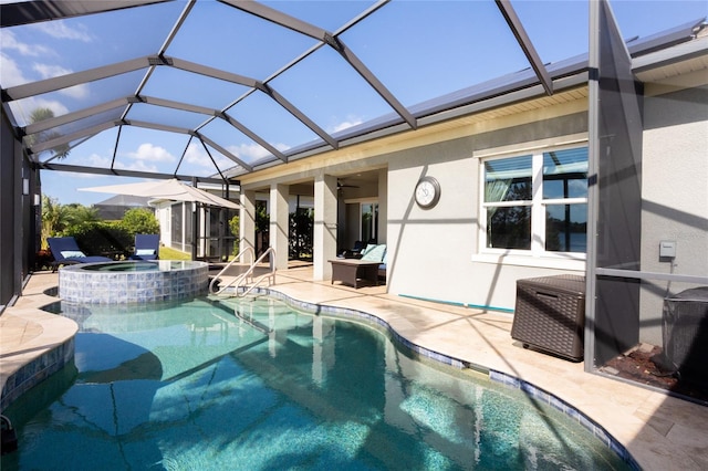 view of pool with a patio area, ceiling fan, an in ground hot tub, and glass enclosure