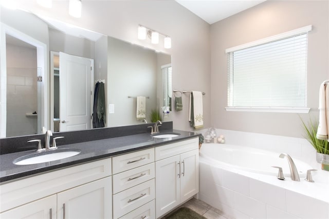 bathroom with vanity, independent shower and bath, and tile patterned flooring