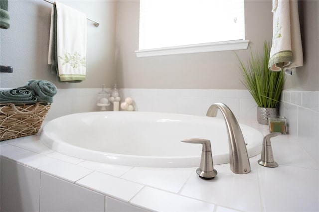 bathroom featuring a relaxing tiled tub