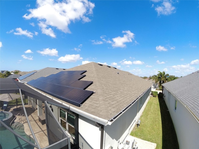 exterior space featuring a fenced in pool and solar panels