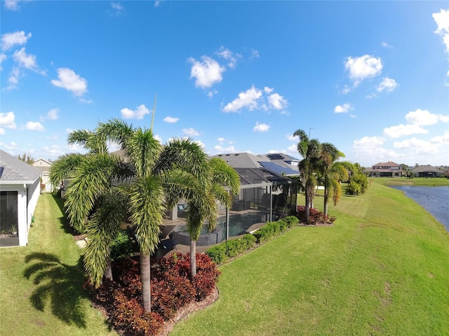 view of yard featuring a water view and glass enclosure