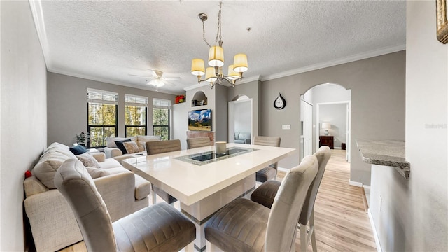 dining space with light hardwood / wood-style floors, crown molding, a textured ceiling, and ceiling fan with notable chandelier