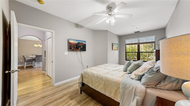 2717 Via Cipriani Unit 622B, Clearwater, FL 33764 - bedroom featuring light wood-style floors, baseboards, a chandelier, and ceiling fan