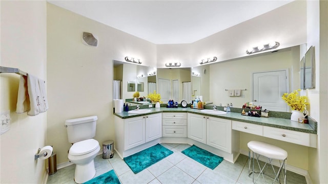 2717 Via Cipriani Unit 622B, Clearwater, FL 33764 - bathroom with tile patterned floors, toilet, and double vanity