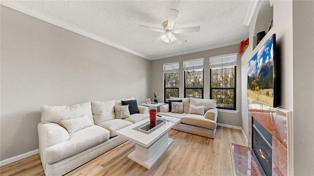 2717 Via Cipriani Unit 622B, Clearwater, FL 33764 - living area with ceiling fan, crown molding, a textured ceiling, light wood-style flooring, and baseboards