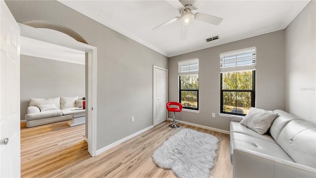 2717 Via Cipriani Unit 622B, Clearwater, FL 33764 - living area with light wood finished floors, a ceiling fan, ornamental molding, and baseboards